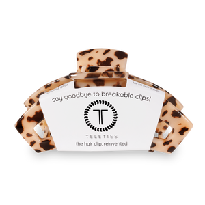 Leopard print hair clip with a label on a white background