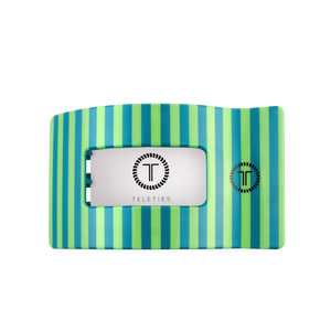 Striped hairclip with a metallic tag featuring 'Teleties' brand on a white background