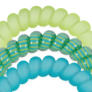 Close-up of green, blue, and striped rubber bands on a white background