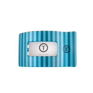 Blue striped hair clip with a silver label featuring 'Teleties' brand on a white background