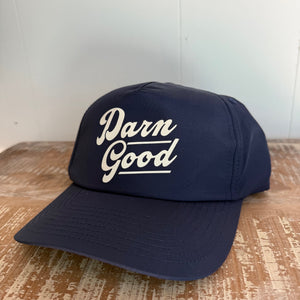 Navy Blue hat with words "Darn Good" across the front