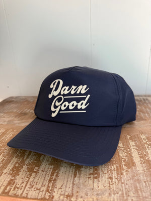 Navy Blue hat with words "Darn Good" across the front