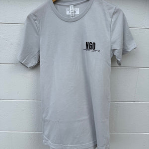 Gray t-shirt with 'NGO' text on a wooden hanger against a light gray wall.