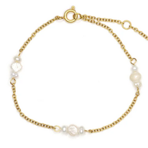 Gold bracelet with pearls on a white background