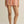 Person wearing striped shorts on a plain background